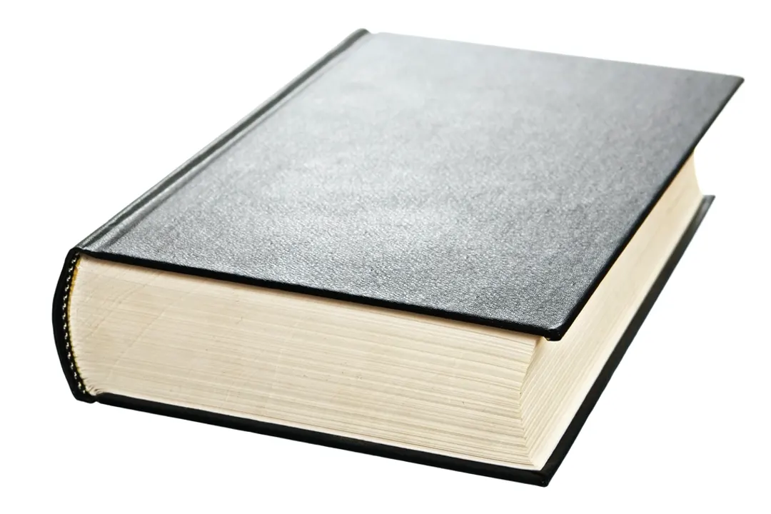 Closed black hardcover book on a white background