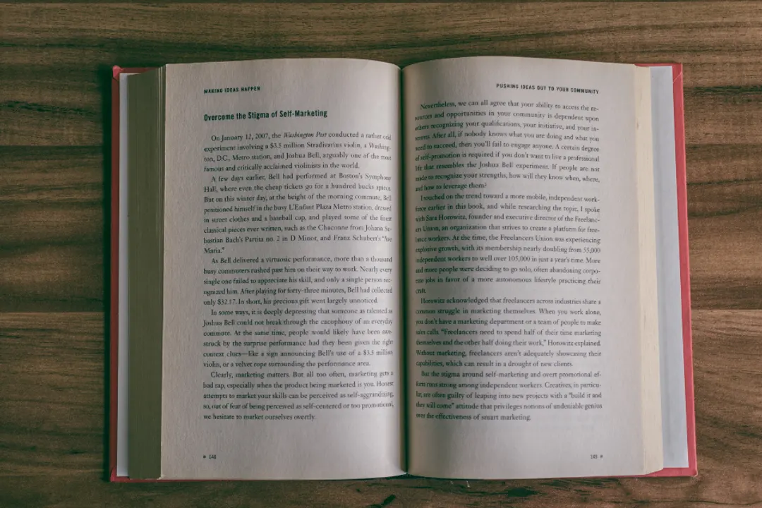 Open book on a wooden table, text laid out across two pages with even margins