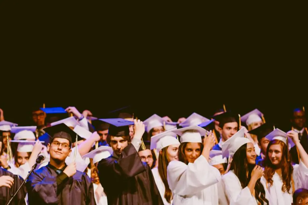 A group of graduates in caps and gowns during a graduation ceremony