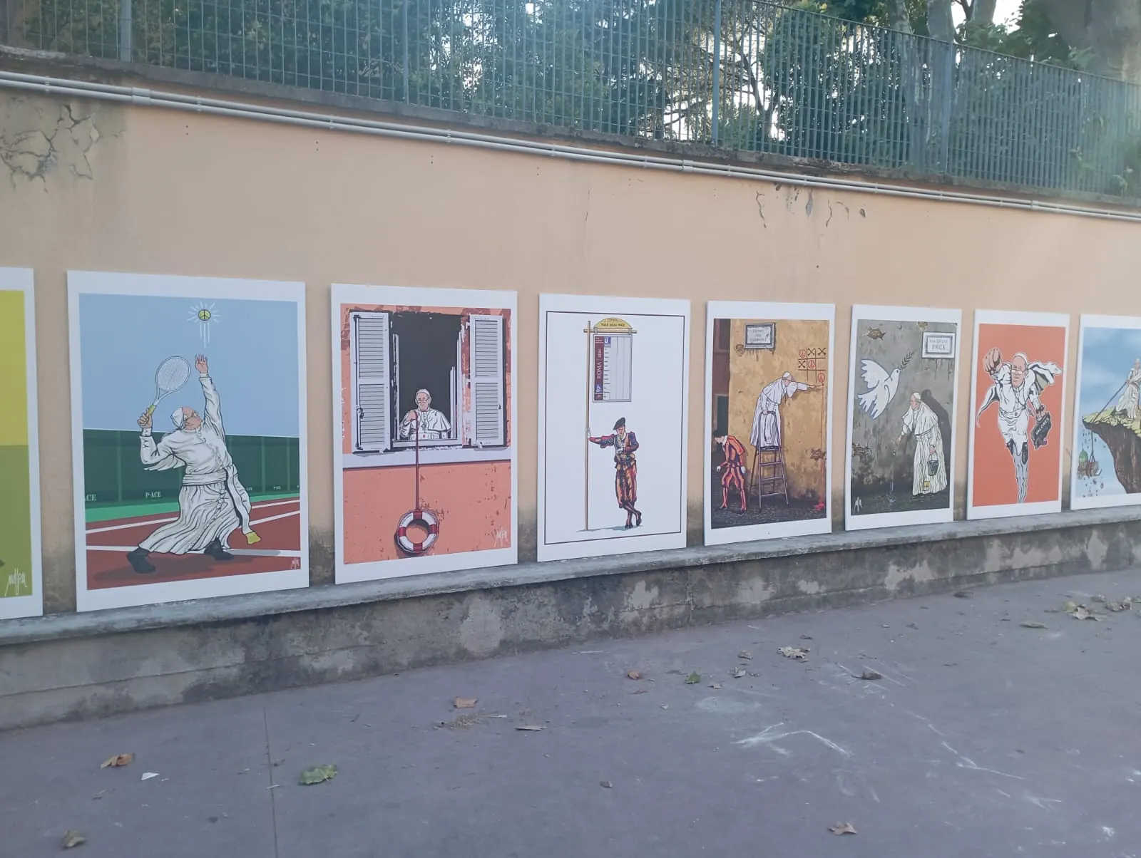 Series of fine art posters printed by GUUG displayed on a street in Rome: street art works featuring Pope Francis, printed on large format photographic paper